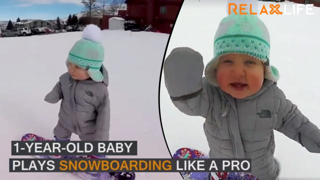 A baby plays snowboarding like a professional