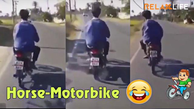 The man rides his motobike as rides a hourse on the street