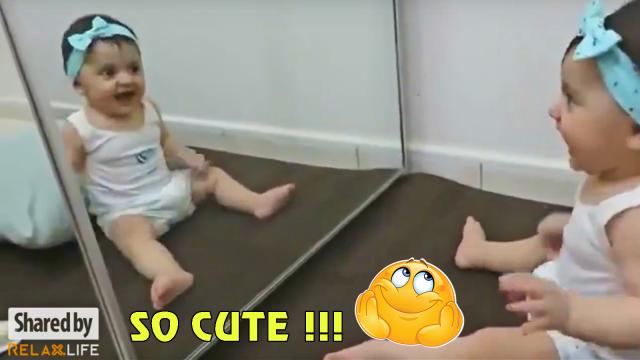 Little girl is happy when she finds herself in the mirror